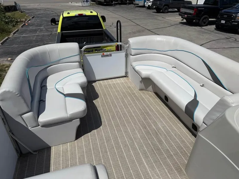 Slide: The Image of 2018 G3 V20C pontoon boat interior with white seating and blue accents. - 10