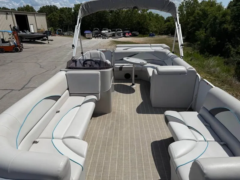 Slide: The Image of 2018 G3 V20C pontoon boat with spacious seating and canopy, parked outdoors. - 11