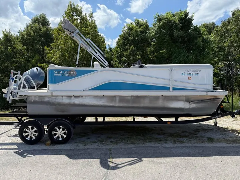 Slide: The Image of 2018 G3 V20C pontoon boat on trailer, parked outdoors with trees in background. - 4