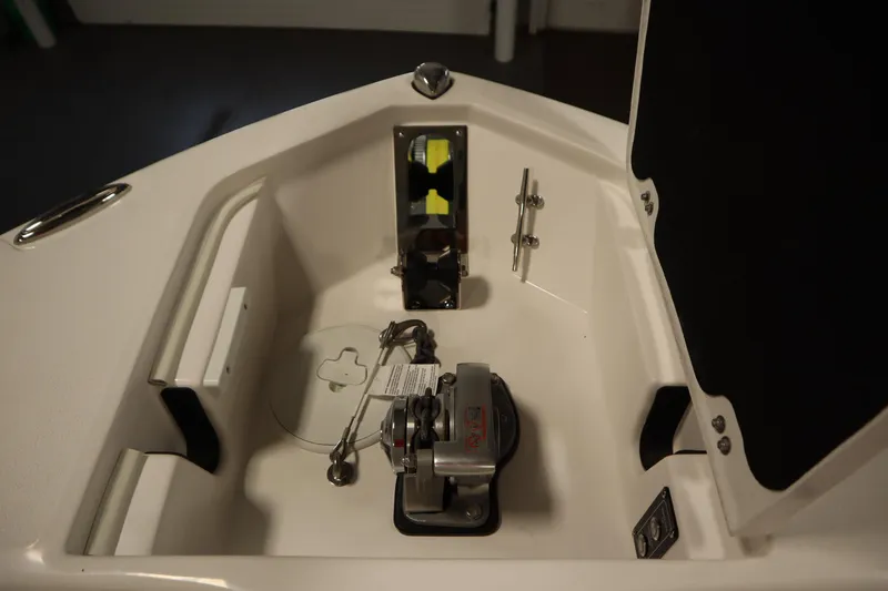 Slide: The Image of 2026 Sea Fox 248 Commander boat anchor compartment with winch and storage features. - 11