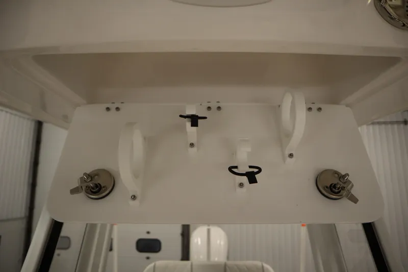 Slide: The Image of 2026 Sea Fox 248 Commander boat interior detail with rod holders and switches. - 19