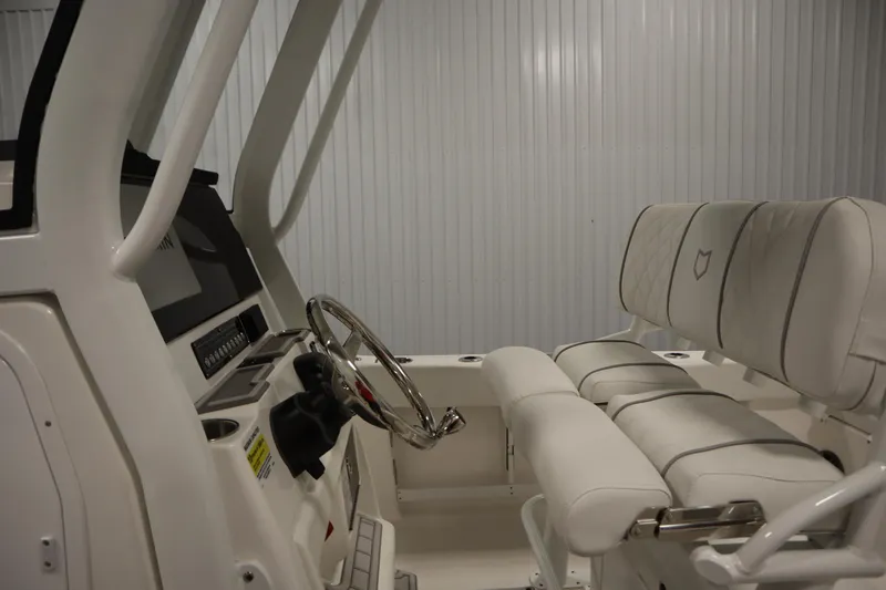 Slide: The Image of 2026 Sea Fox 248 Commander boat interior with steering wheel and cushioned seating. - 24