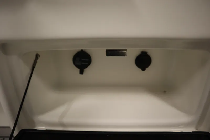 Slide: The Image of 2026 Sea Fox 248 Commander storage compartment with two black knobs and a support rod. - 35