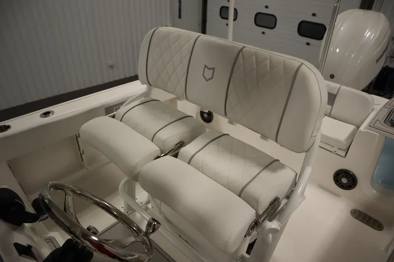 Slide: The Image of 2026 Sea Fox 248 Commander boat interior with luxurious white seating and steering wheel. - 37