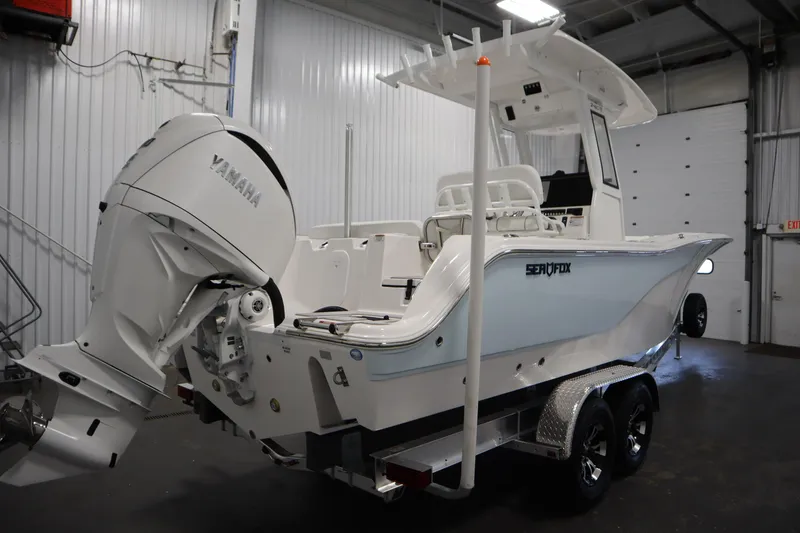 Slide: The Image of 2026 Sea Fox 248 Commander boat with Yamaha engine in a garage setting. - 4