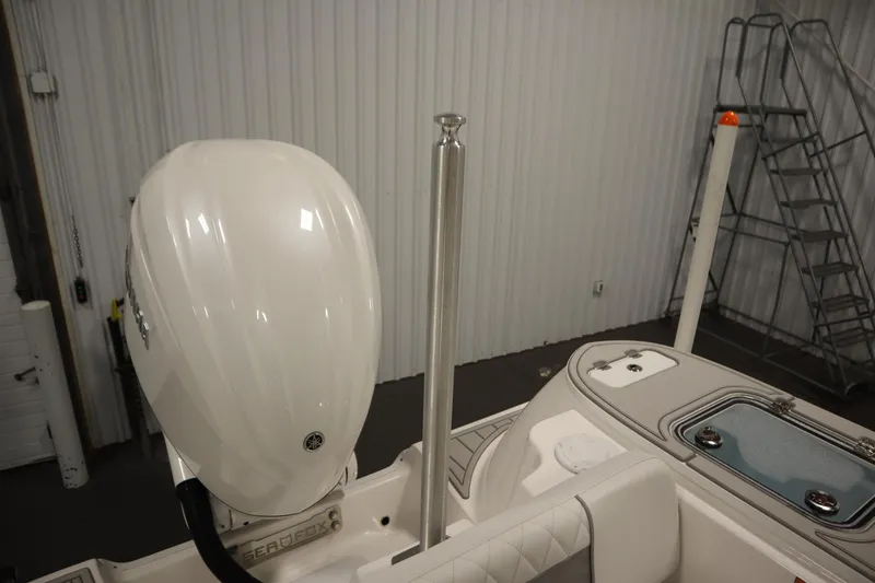 Slide: The Image of 2026 Sea Fox 248 Commander boat engine and deck details in a storage facility. - 50