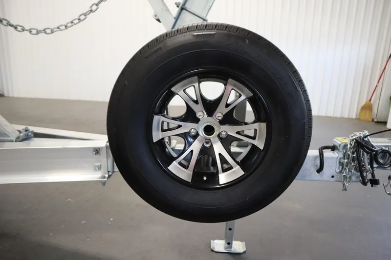 Slide: The Image of Trailer wheel on a 2026 Sea Fox 248 Commander boat trailer in a garage setting. - 57