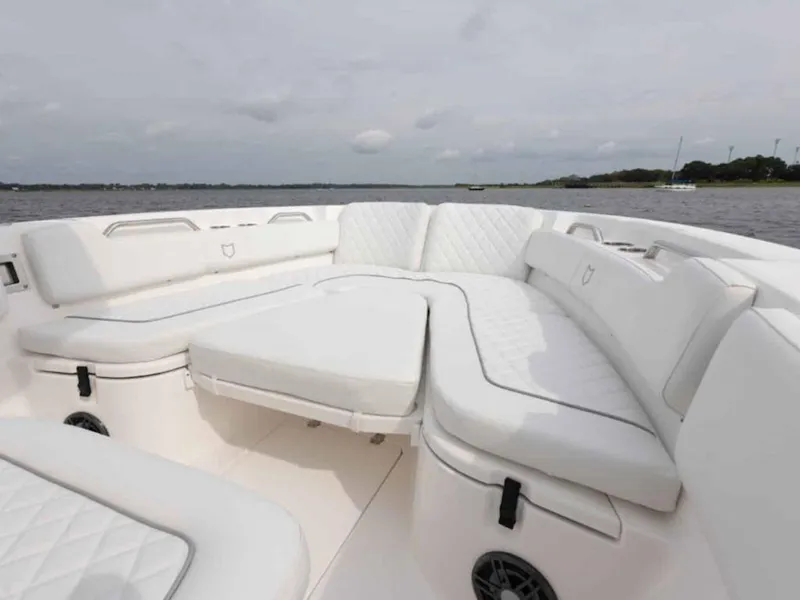 Slide: The Image of 2026 Sea Fox 248 Commander boat interior with white cushioned seating on a calm water backdrop. - 67