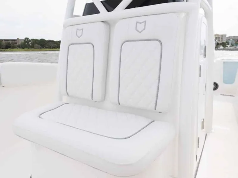Slide: The Image of 2026 Sea Fox 248 Commander boat with white cushioned seating, featuring elegant stitching. - 72