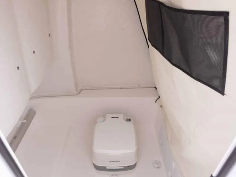 Slide: The Image of 2026 Sea Fox 248 Commander boat interior with portable toilet and storage net. - 78