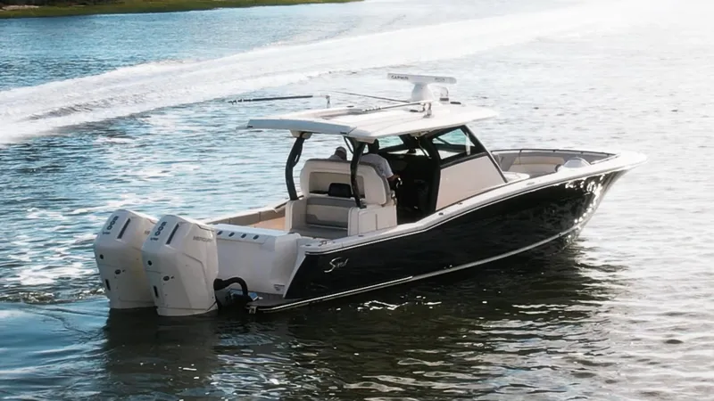 Slide: The Image of 2023 Scout 377 LXF boat cruising on water with dual engines. - 10