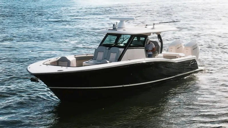 Slide: The Image of 2023 Scout 377 LXF boat cruising on open water, showcasing sleek design and luxury features. - 11