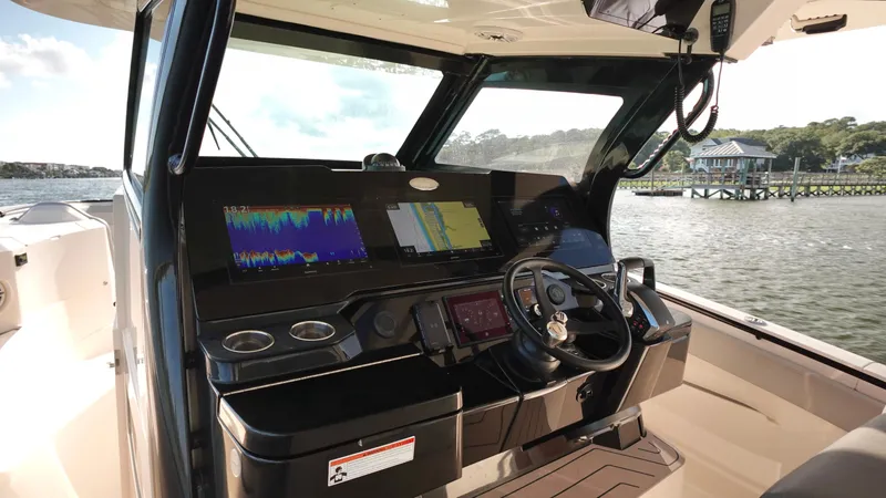 Slide: The Image of 2023 Scout 377 LXF boat helm with advanced navigation displays and controls. - 14