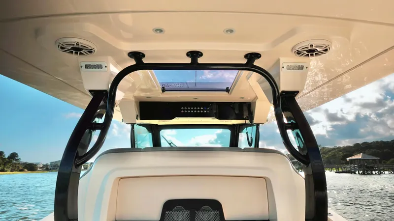Slide: The Image of 2023 Scout 377 LXF boat interior with speakers and open water view. - 17