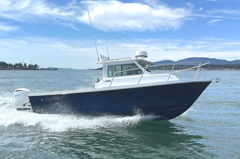The Image of 2026 Parker 227 Explorer boat cruising on open water under a clear blue sky. - 0