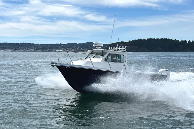 Slide: The Image of 2026 Parker 227 Explorer boat cruising on open water with scenic background. - 10