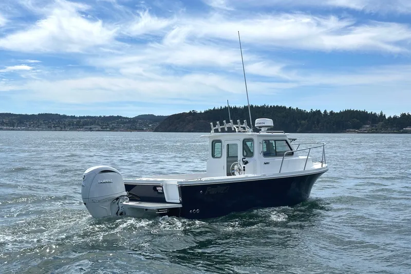 Slide: The Image of 2026 Parker 227 Explorer boat cruising on a scenic lake under a blue sky. - 12
