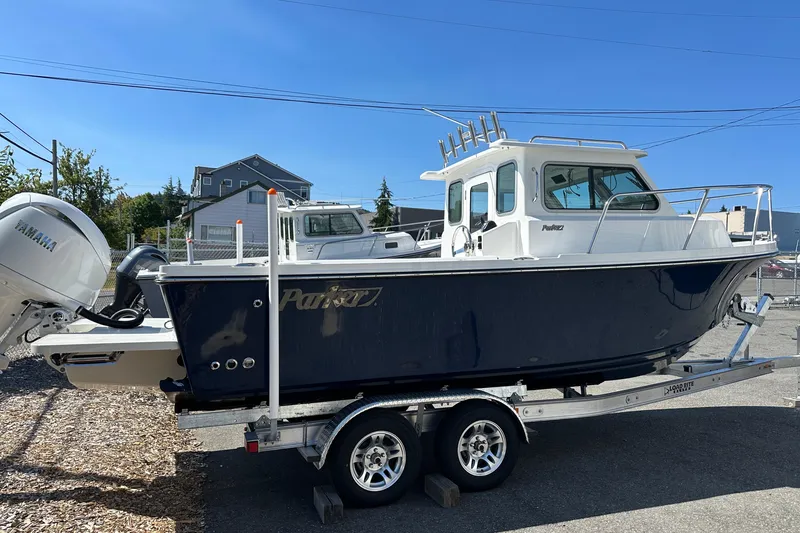 Slide: The Image of 2026 Parker 2220 boat on trailer with Yamaha engine, parked outdoors. - 18