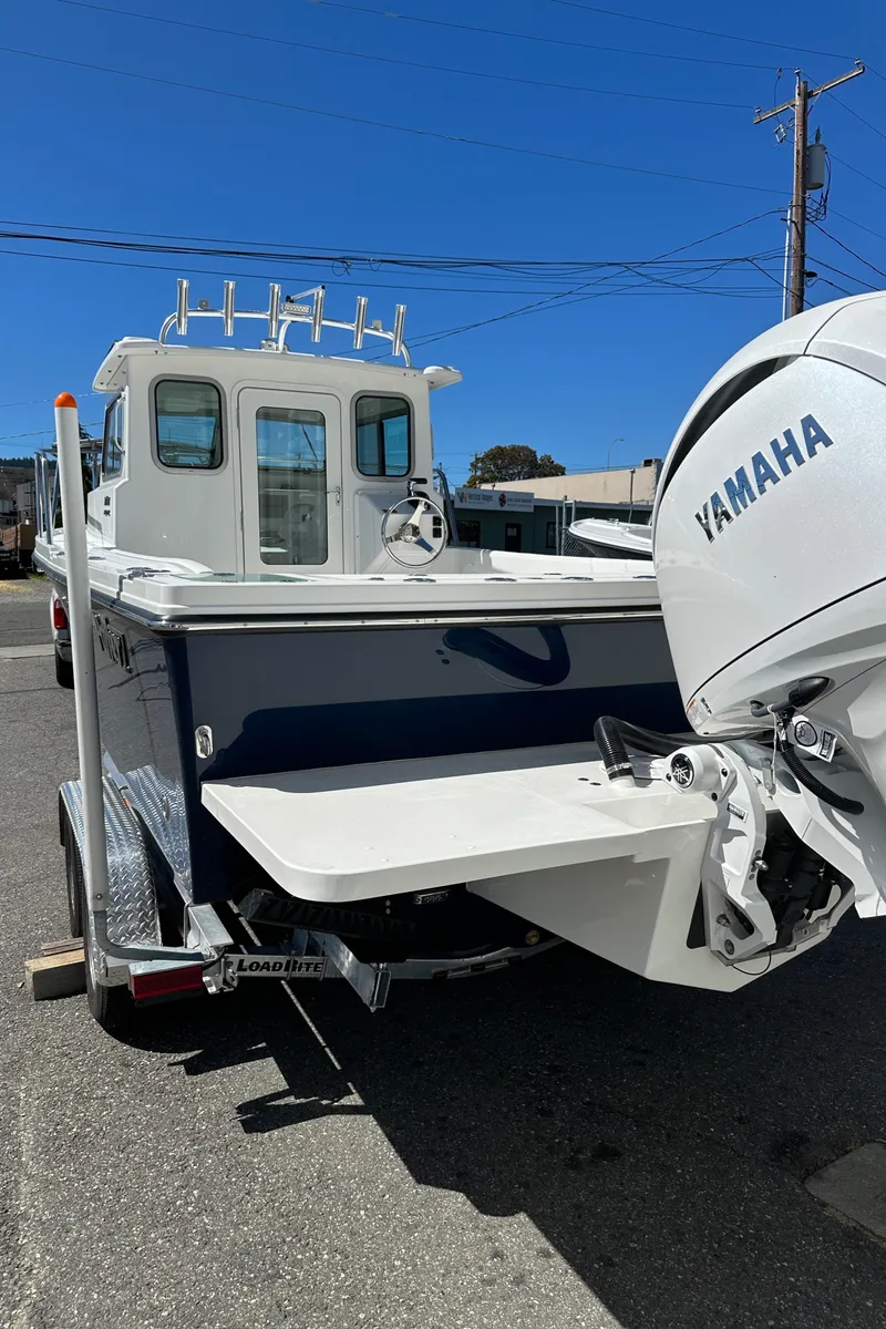 Slide: The Image of 2026 Parker 2220 boat with Yamaha engine on trailer, parked outdoors. - 19