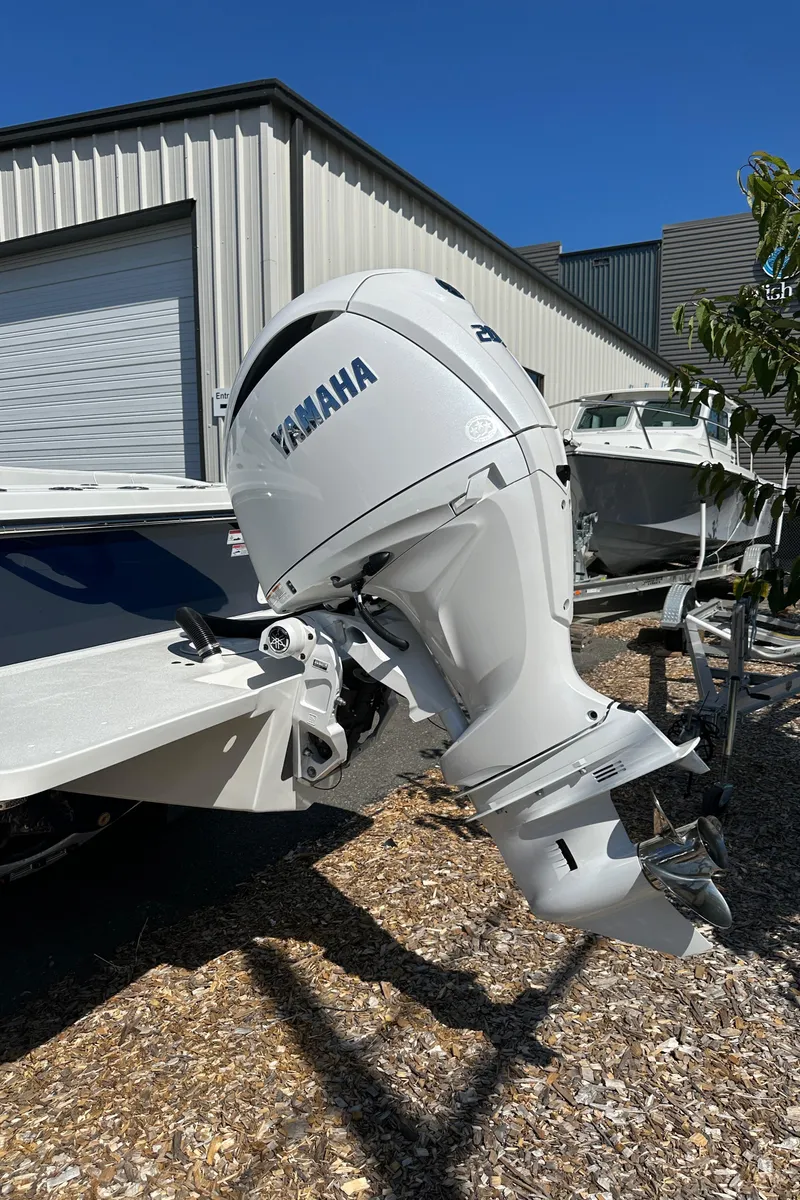 Slide: The Image of Yamaha outboard motor on Parker 2220 boat, 2026 model, parked outdoors near a building. - 20