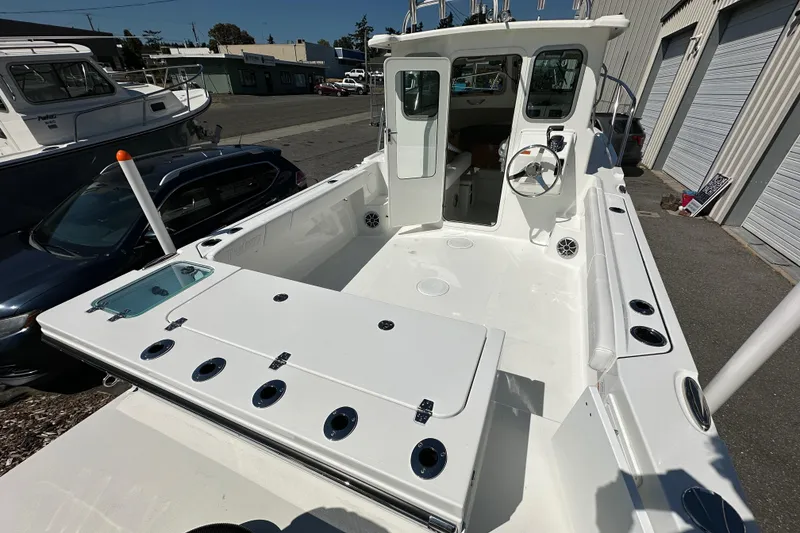 Slide: The Image of 2026 Parker 2220 boat with spacious deck and modern cockpit, parked outdoors. - 21