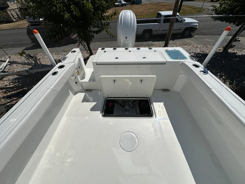 Slide: The Image of 2026 Parker 2220 boat deck with storage compartments and fishing rod holders. - 27