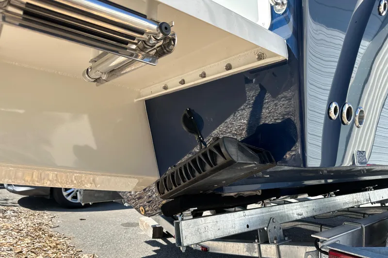 Slide: The Image of 2026 Parker 2220 boat on trailer, showcasing hull and trim tabs. - 28