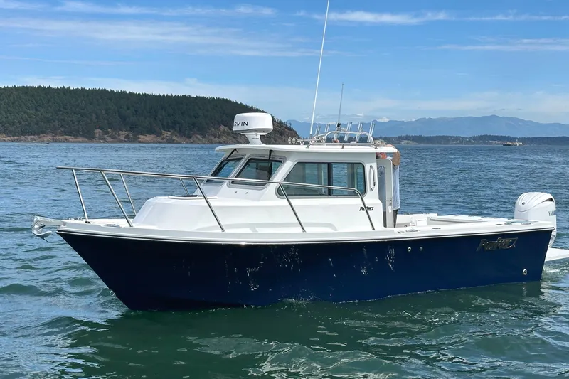 Slide: The Image of 2026 Parker 227 Explorer boat cruising on a scenic lake with forested hills. - 3