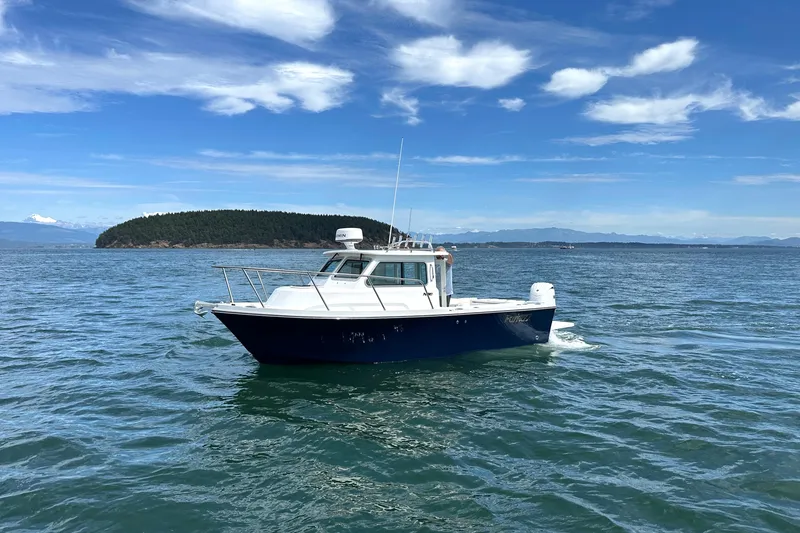 Slide: The Image of 2026 Parker 227 Explorer boat cruising on open water under a clear blue sky. - 34