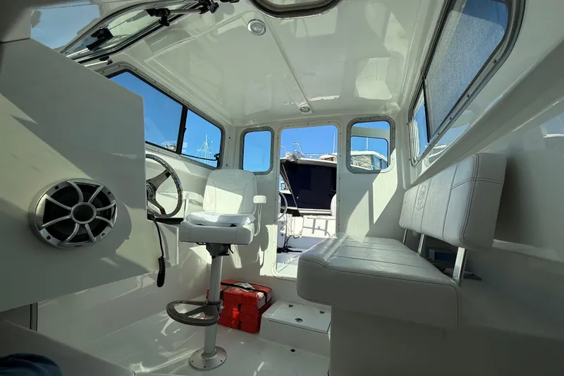 Slide: The Image of Interior of 2026 Parker 227 Explorer boat with seating and steering wheel. - 36