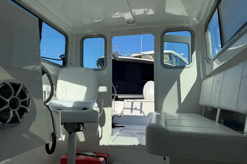 Slide: The Image of Interior of 2026 Parker 227 Explorer boat with white seating and windows. - 37
