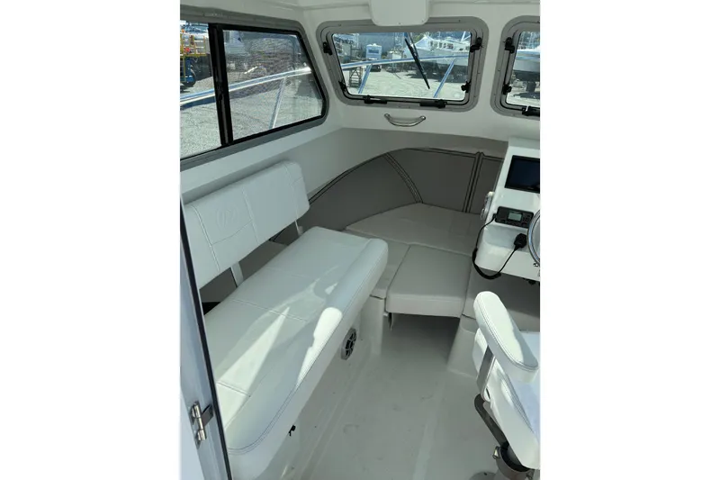 Slide: The Image of Interior of 2026 Parker 227 Explorer boat with white seating and helm. - 38
