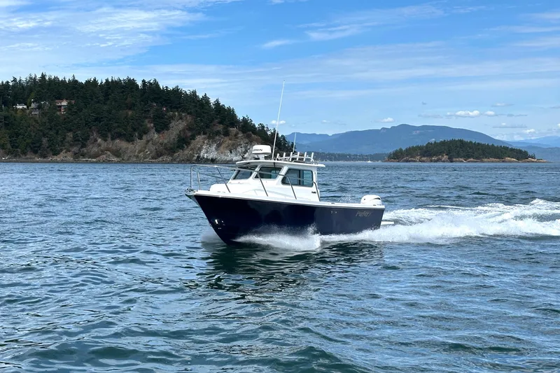 Slide: The Image of 2026 Parker 227 Explorer boat cruising on scenic coastal waters. - 5