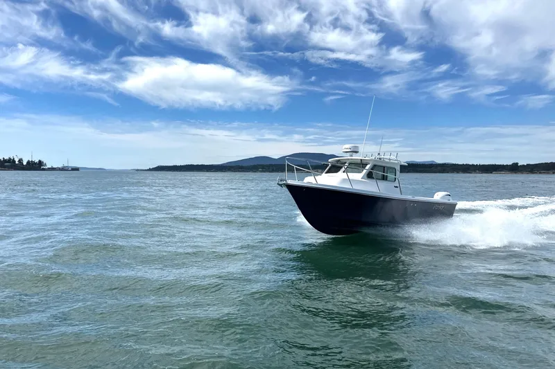 Slide: The Image of 2026 Parker 227 Explorer boat cruising on open water under a clear blue sky. - 6