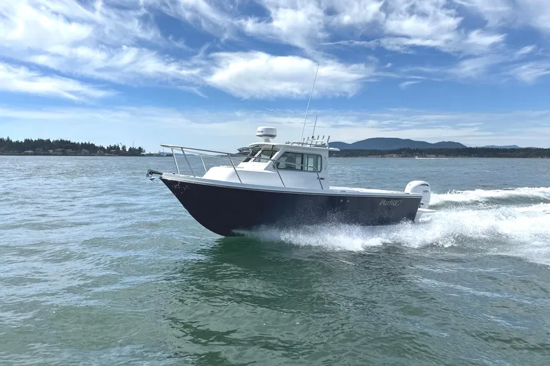 Slide: The Image of 2026 Parker 227 Explorer boat cruising on open water under a clear blue sky. - 7