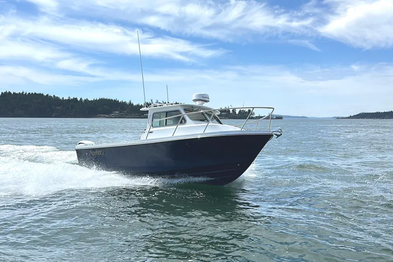 Slide: The Image of 2026 Parker 227 Explorer boat cruising on open water under a clear blue sky. - 8