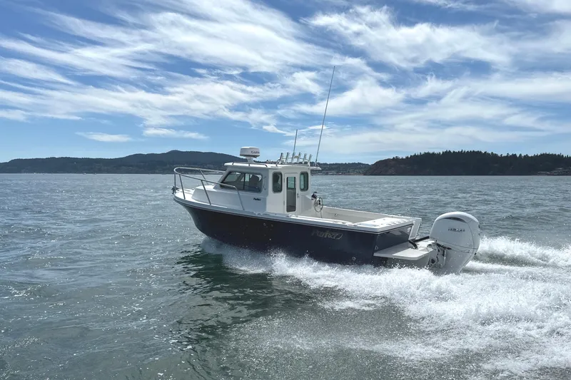 Slide: The Image of 2026 Parker 227 Explorer boat cruising on open water under a clear sky. - 9