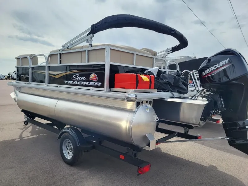 Slide: The Image of 2025 Sun Tracker Party Barge 16 DLX pontoon boat on trailer with Mercury outboard motor. - 4