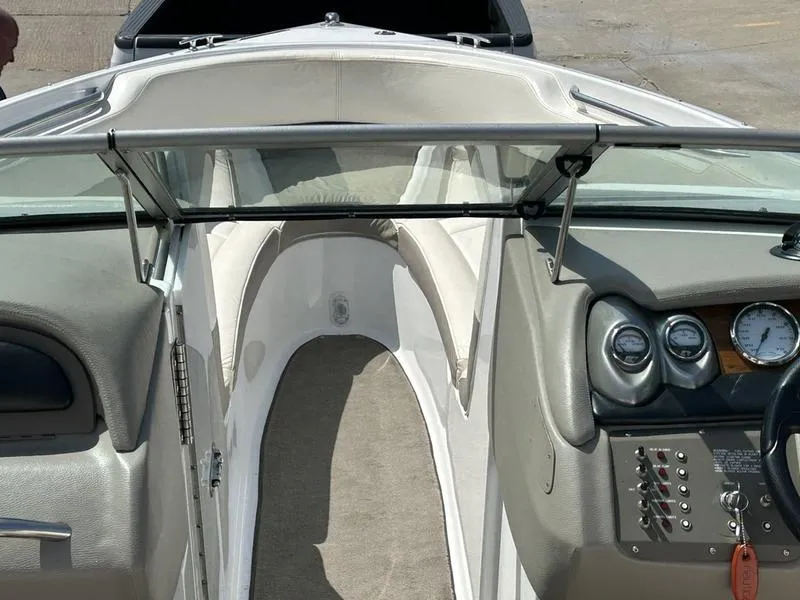 Slide: The Image of 2006 Cobalt 250 boat interior with dashboard, steering wheel, and seating area. - 12