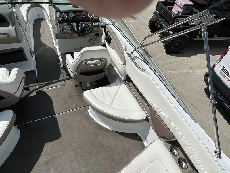 Slide: The Image of Interior of a 2006 Cobalt 250 boat with white seating and modern dashboard. - 14