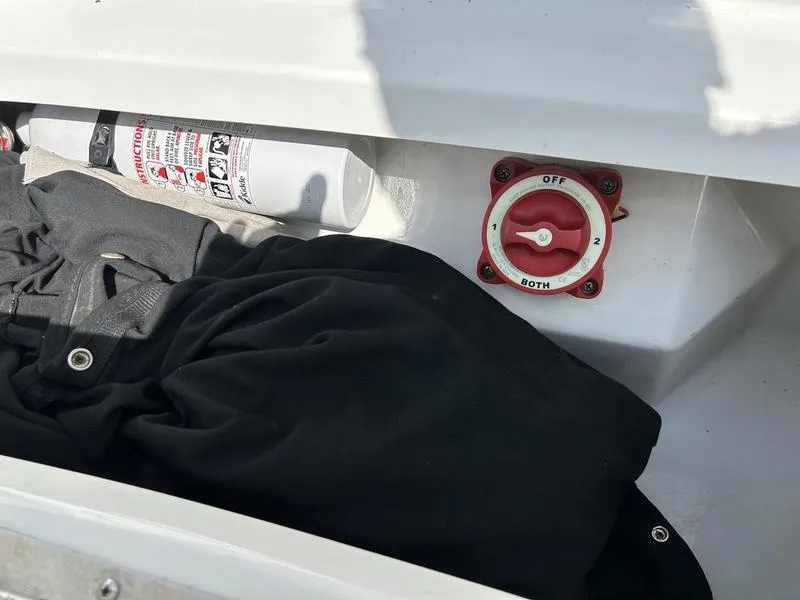 Slide: The Image of Storage compartment in a 2006 Cobalt 250 boat with fire extinguisher and battery switch. - 16