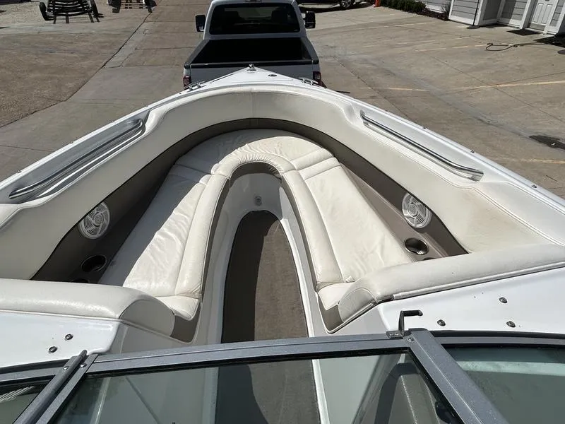 Slide: The Image of 2006 Cobalt 250 boat interior with white seating and cup holders. - 7