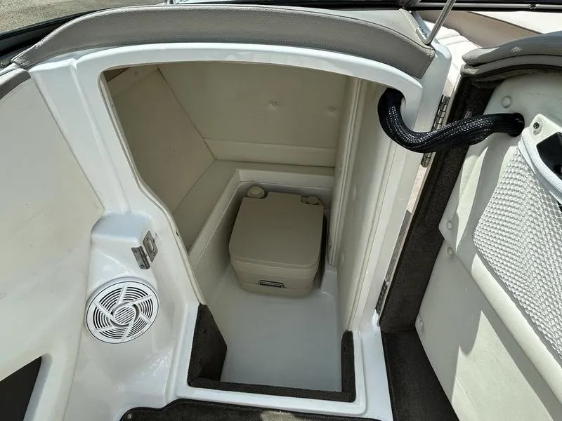Slide: The Image of 2006 Cobalt 250 boat interior with compact toilet and speaker. - 9