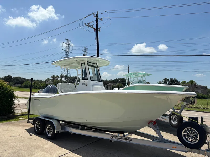 The Image of 2026 Tidewater 232 LXF boat on trailer under clear blue sky. - 1