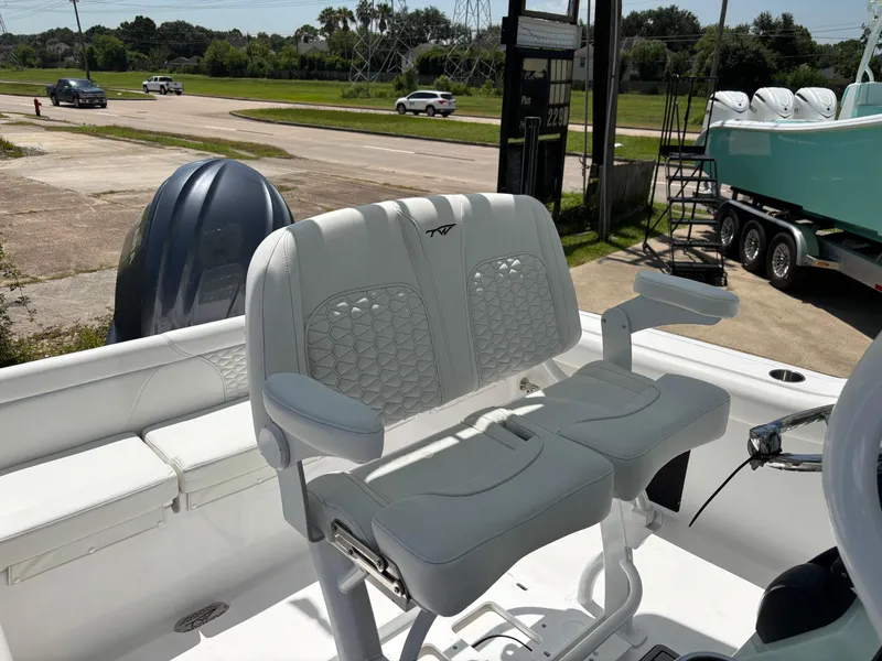 Slide: The Image of 2026 Tidewater 232 LXF boat interior with white seating and steering wheel. - 3