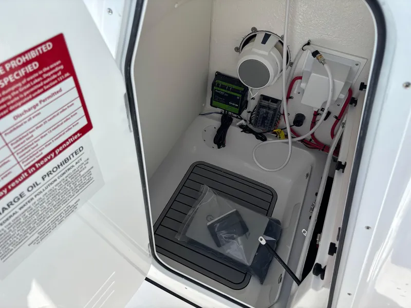 Slide: The Image of Electrical compartment of 2026 Tidewater 232 LXF boat, featuring wiring and equipment. - 9