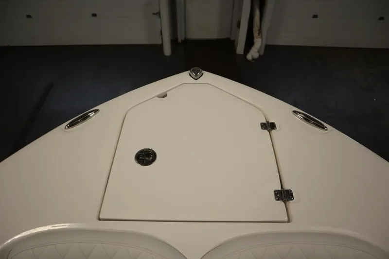 Slide: The Image of 2026 Sea Fox 228 Commander boat deck with storage compartment and stainless steel fixtures. - 11