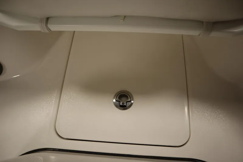 Slide: The Image of 2026 Sea Fox 228 Commander boat storage compartment with secure latch. - 15