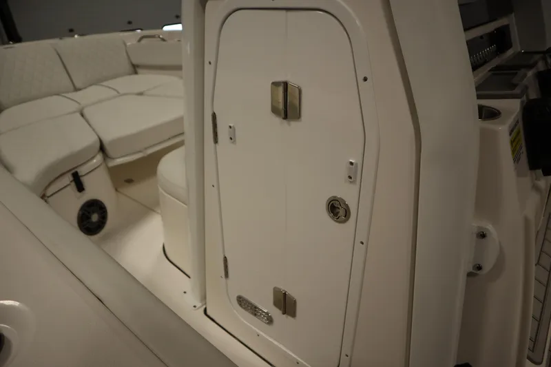 Slide: The Image of 2026 Sea Fox 228 Commander interior with cushioned seating and storage compartment. - 22