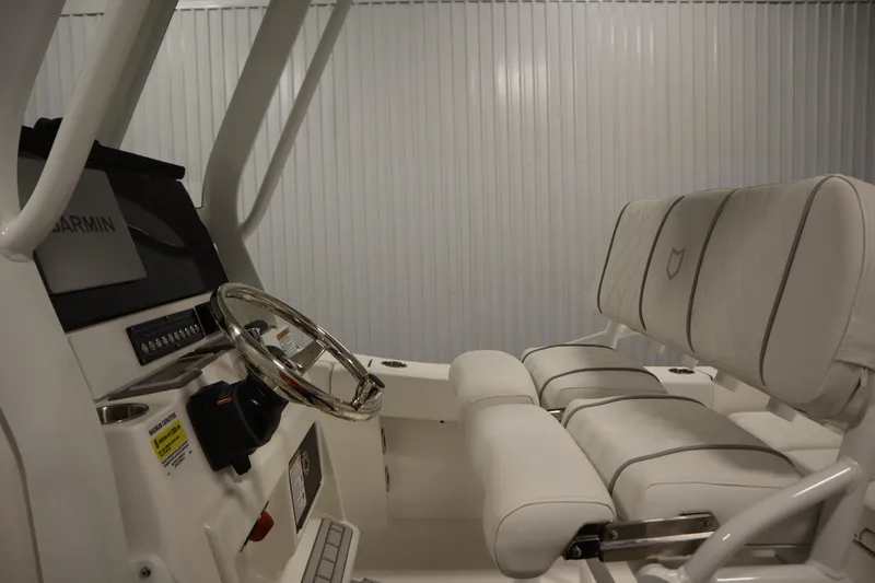 Slide: The Image of 2026 Sea Fox 228 Commander boat interior with steering wheel and cushioned seating. - 24